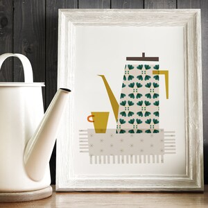 May include: A white framed print featuring a green and white patterned coffee pot, a yellow cup, and a beige tablecloth with a white star pattern.