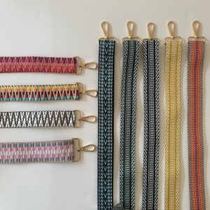 May include: Seven different woven straps with gold metal clasps. The straps are in various colours and patterns, including black and white, green and white, yellow and white, red and white, and pink and grey.