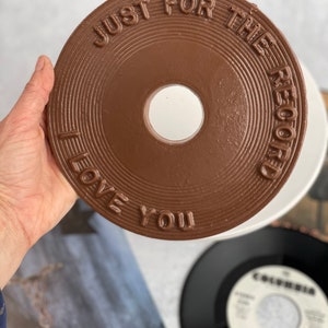 May include: A brown chocolate record with the text "Just for the record I love you" on it.