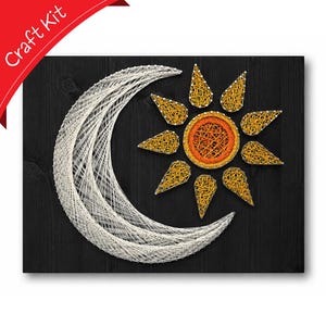 May include: A string art craft kit on a black wooden board featuring a white crescent moon and a sun with a bright orange center and yellow rays created with nails and thread. The text Craft Kit appears in the top left corner.