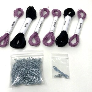 May include: A set of embroidery floss in purple and black colors, with labels that read "Purple 1", "Black", "Purple 2", "Purple 3", "Black", and "Purple 4". The set also includes a bag of silver tacks and a metal hook with two screws.