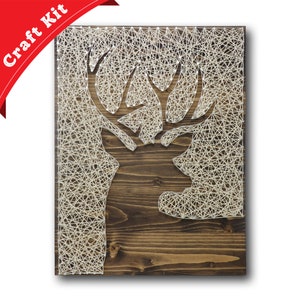 May include: A wooden craft kit featuring a deer head design. The deer head is created using white string wrapped around nails hammered into the wood. The kit includes all the necessary materials to create the deer head.