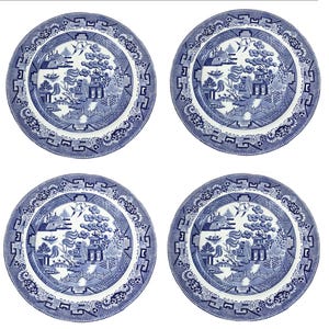 May include: A set of four round ceramic plates featuring a blue and white willow pattern. Each plate displays a detailed landscape illustration with a pagoda, a bridge, trees, and birds, surrounded by a decorative geometric border design.