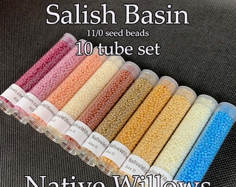 May include: A set of 10 tubes of 11/0 seed beads in various colors, including pink, peach, beige, gold, and blue. The tubes are labeled "Native Willows" and "Size 11". The beads are 9/16 inches long and 3 inches in diameter, and each tube contains 15 grams of beads. The set is labeled "Salish Basin 10 tube set".