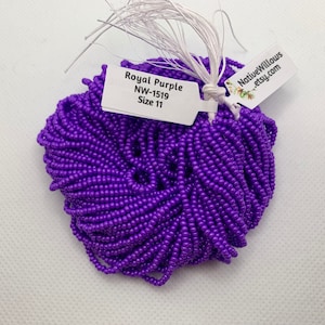Puede incluir: Un montón de pequeñas cuentas de color púrpura real. Una etiqueta blanca dice "Royal Purple NW-1519 Size 11". Otra etiqueta muestra "NativeWillows etsy.com". Las cuentas están muy juntas, formando una masa densa y texturizada.