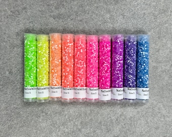 May include: Ten small tubes of colourful seed beads, each labelled "Native Willow" and "Size 11". The beads are arranged in a rainbow pattern from green to blue.