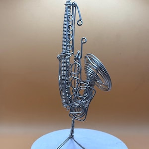 Création artistique représentant un saxophone, en fil métallique, parfaite pour une décoration musicale.