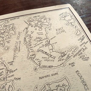 A close up of the details of the map, including the ocean, trees, and mountains.