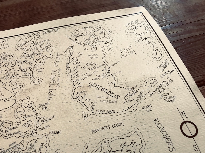A close up of the details of the map, including the ocean, trees, and mountains.