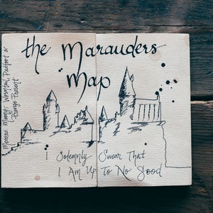 May include: A hand-drawn map of Hogwarts castle with the text "the Marauders map" and "I solemnly swear that I am up to no good".
