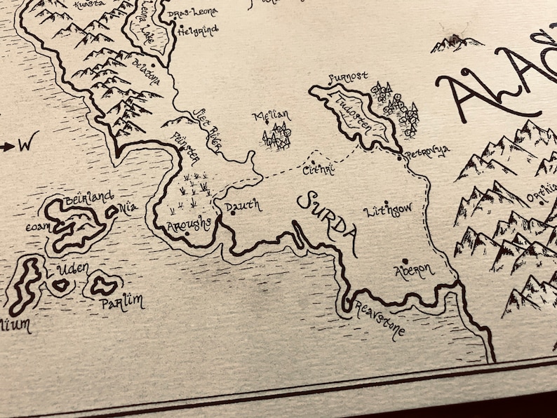 A close up of the details of the map, including the ocean, trees, and mountains.