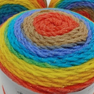 May include: A skein of rainbow colored yarn with silver glitter thread woven throughout. The yarn is wound into a ball shape.