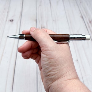 Holding 2mm mechanical pencil as if writing with it - side view