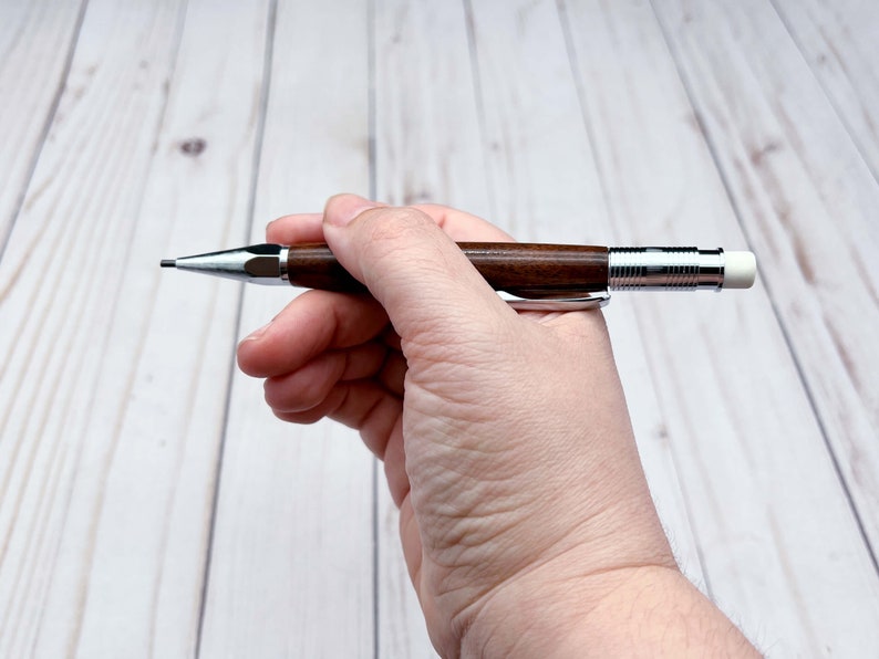 Holding 2mm mechanical pencil as if writing with it - side view