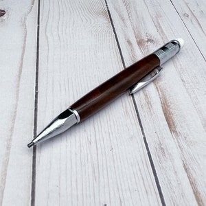 Full view of 2mm mechanical pencil made in black walnut wood - laying flat - showing pencil lead