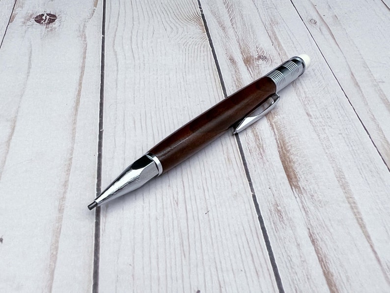 Full view of 2mm mechanical pencil made in black walnut wood - laying flat - showing pencil lead