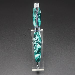 Front view of green and white (aka seafoam green) princess pen with blue crystals and chrome hardware on clear pen stand.