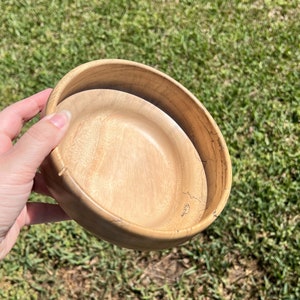 Camphor bowl with wide opening and narrower base - angled view to show the inside bottom of the wooden bowl