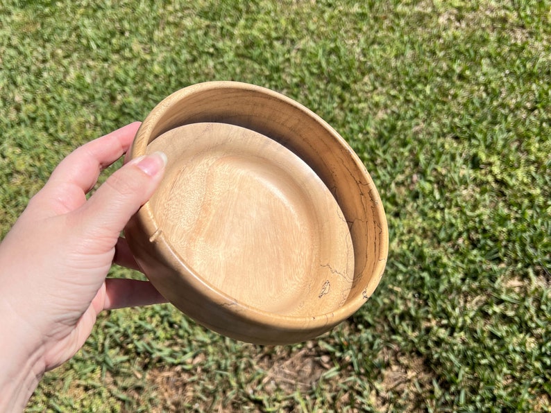 Camphor bowl with wide opening and narrower base - angled view to show the inside bottom of the wooden bowl