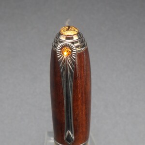 Close-up view of top of fountain pen made of ringed gidgee wood - to show off gold art deco detailing and crystal.