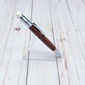 Full view of 2mm mechanical pencil made in black walnut wood - from the side - in a pencil holder.