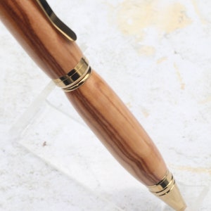 Close-up of olive wood pen barrel for Titanium Gold Cigar Pen made with olive wood and gold hardware