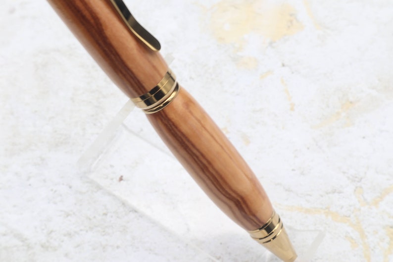 Close-up of olive wood pen barrel for Titanium Gold Cigar Pen made with olive wood and gold hardware