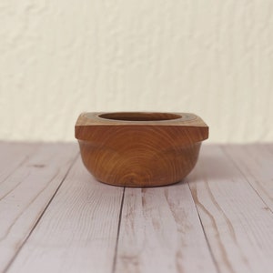 Osage Orange wooden bowl with square top and round opening and bowl - side view