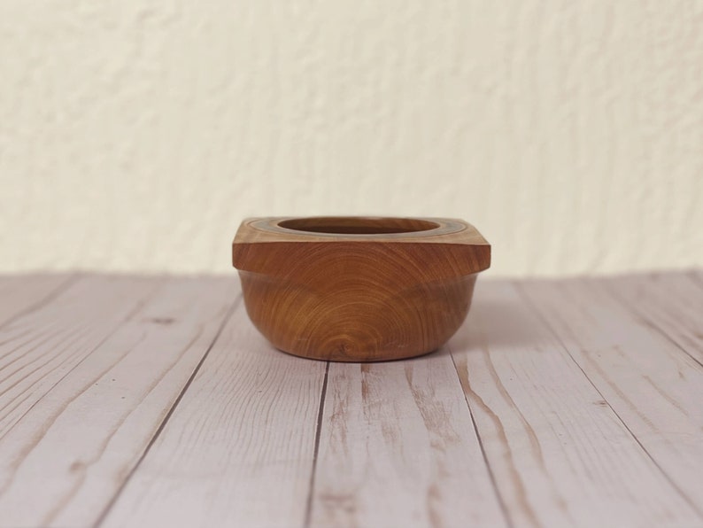 Osage Orange wooden bowl with square top and round opening and bowl - side view