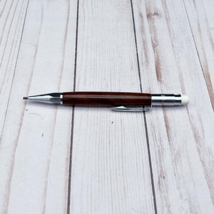 Full view of 2mm mechanical pencil made in black walnut wood - laying flat
