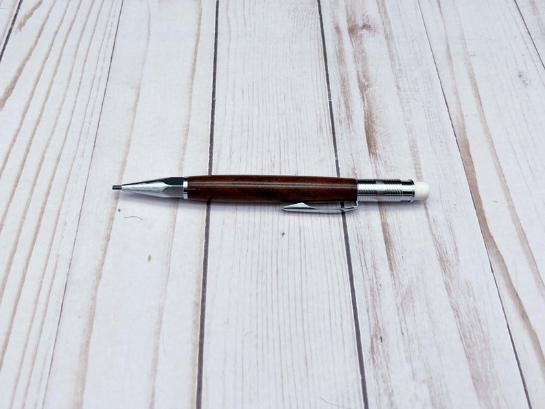 Full view of 2mm mechanical pencil made in black walnut wood - laying flat