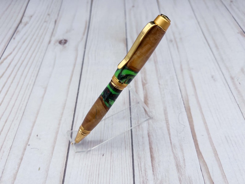 Side view of olive wood and resin twist pen with satin gold hardware