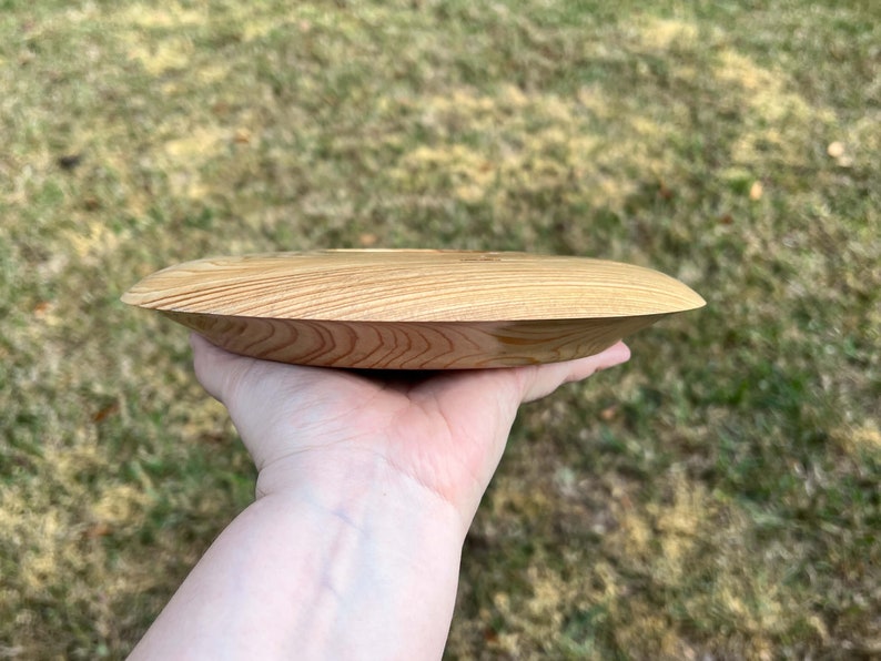 Cypress wooden potpourri bowl - being held in natural light - side view