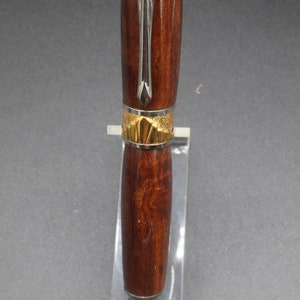 Close-up view of center of fountain pen made of ringed gidgee wood - to show off gold art deco detailing.