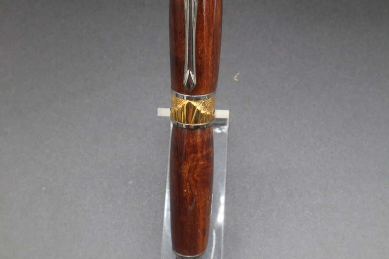 Close-up view of center of fountain pen made of ringed gidgee wood - to show off gold art deco detailing.