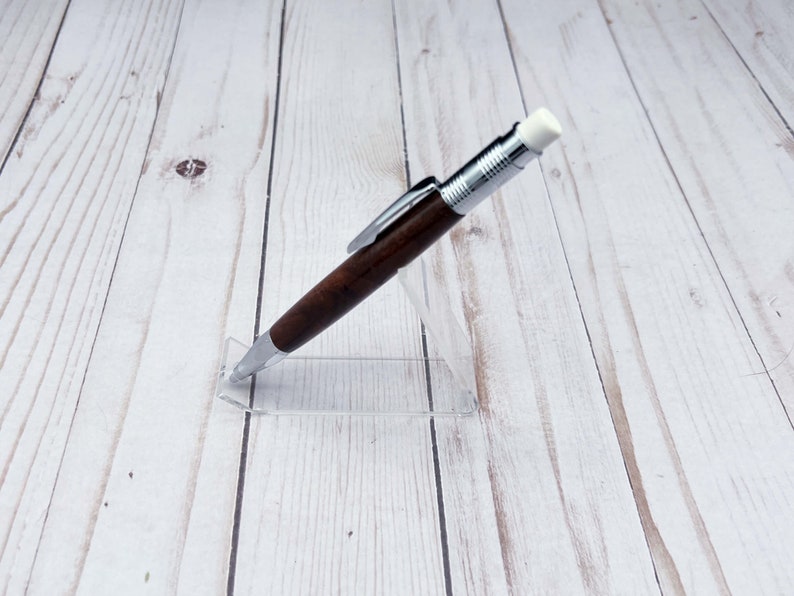 Full view of 2mm mechanical pencil made in black walnut wood - from the side - in a pencil holder.