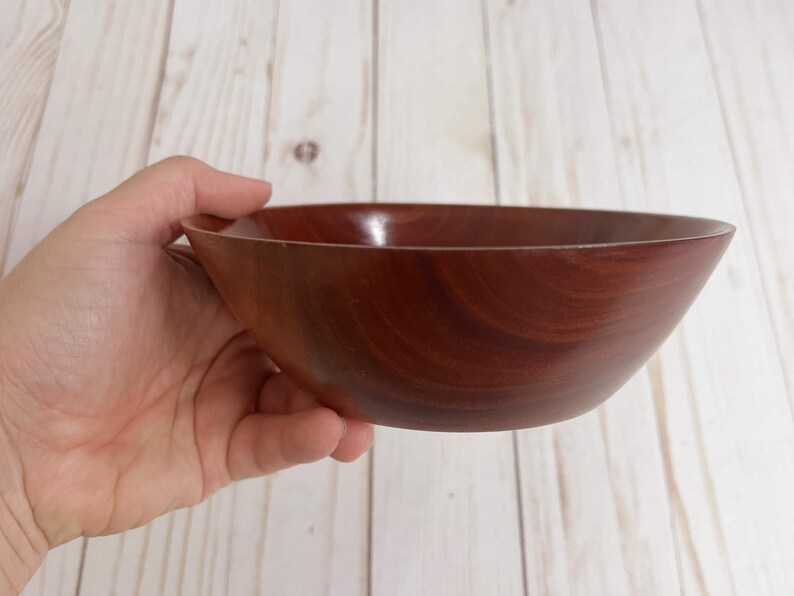 Eucalyptus wood bowl - holding so you can see size, showing the side