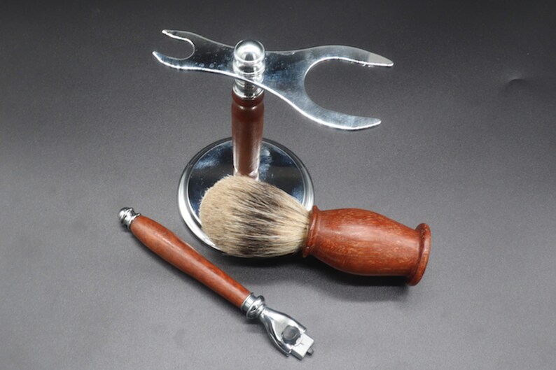 Eucalyptus shaving set with brush, stand, and razor handle over a dark background