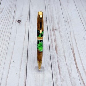 Front view of olive wood and resin twist pen with satin gold hardware