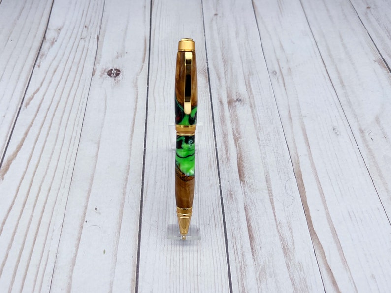 Front view of olive wood and resin twist pen with satin gold hardware