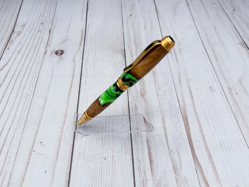 Side view of olive wood and resin twist pen with satin gold hardware