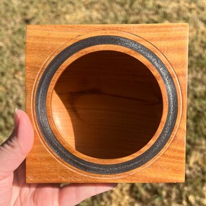 Osage Orange wooden bowl with square top and round opening and bowl - being held in natural light, view into the bowl