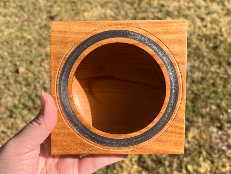 Osage Orange wooden bowl with square top and round opening and bowl - being held in natural light, view into the bowl