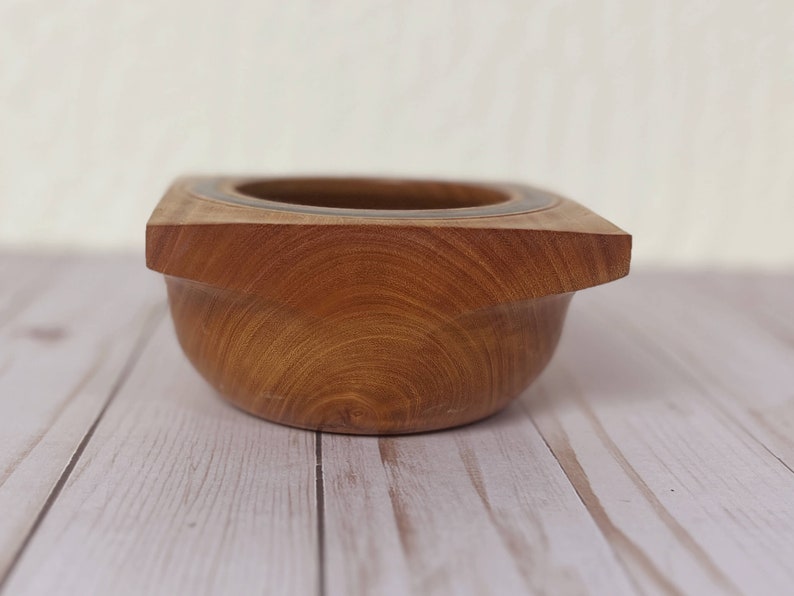 Osage Orange wooden bowl with square top and round opening and bowl - close-up side view