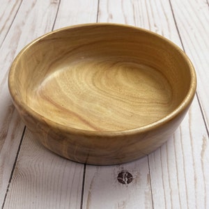 Shallow bowl made from camphor wood - angled view to show side and inside of bowl