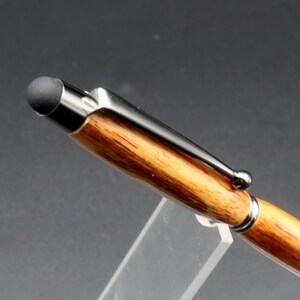 Close up view of stylus tip for Canarywood stylus pen with gun metal hardware in pen stand over black background