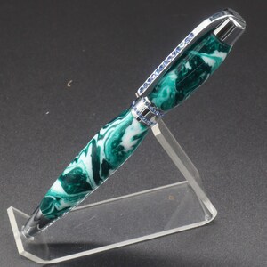 Full side view of green and white (aka seafoam green) princess pen with blue crystals and chrome hardware on clear pen stand.