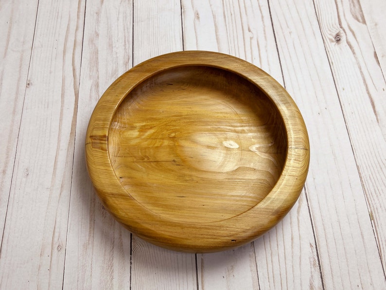 Shallow bowl made of Cypress wood - top down view from angle