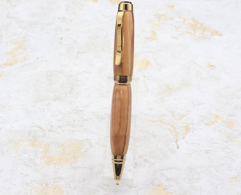 Front view in clear pen stand of Titanium Gold Cigar Pen made with olive wood and gold hardware