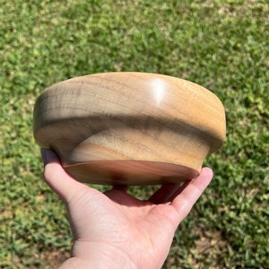 Camphor bowl with wide opening and narrower base - another side view of wooden bowl in natural light